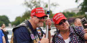 Dion Cini (right) takes a selfie with a fellow Trump supporter outside court.