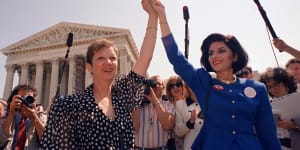 Norma McCorvey,Jane Roe in the 1973 court case,(left) and her attorney Gloria Allred hold hands outside the Supreme Court in Washington in 1989.