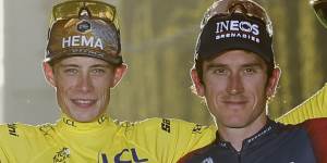 Tour de France winner Denmark’s Jonas Vingegaard in the yellow jersey,second place Slovenia’s Tadej Pogacar,left,and third place Britain’s Geraint Thomas,