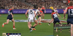 Melbourne’s Kysaiah Pickett delivers a high bump on Patrick Cripps.