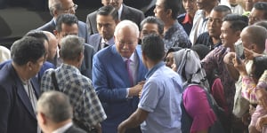 Former Malaysian prime minister Najib Razak,centre,arrives at court in Kuala Lumpur for his trial on Tuesday.