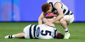 Jeremy Cameron was taken to hospital after the clash with teammate Gary Rohan (crouching).