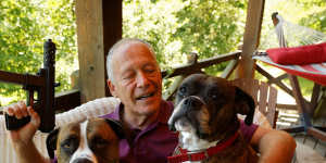 Richard Feldman at his home in Rindge,New Hampshire with his dogs Stanley and Stella and a version of the TEC-9.