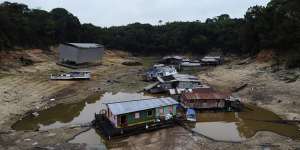 Boats and houseboats are stuck in a dry area of the Negro River during a drought in Manaus,Amazonas state,Brazil.