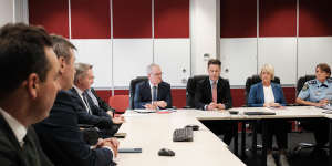 NSW Premier Chris Minns (third from right) with other MPs and community leaders at Fairfield police station on Tuesday.