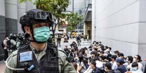Riot police round up a group of protesters during a demonstration on Wednesday May 27. 