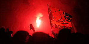 The glowing red flare haze at Federation Square after the Socceroos scored.