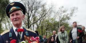 Honours:A girl gives flowers to a veteran at a monument to the Unknown Sailor during celebrations marking Victory Day in Odessa. WWII veterans salute at a war memorial during Victory Day celebrations.