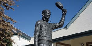 The statue of Sir Don Bradman by the artist Tanya Bartlett standing in front of the Bradman museum in Bowral.