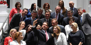 Former state development minister Cameron Dick (centre) takes a selfie with his fellow ministers after a swearing in ceremony in 2017.
