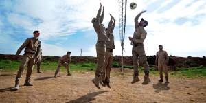 New conscripts to Rojava's army play volleyball during a break from training at an abandoned Syrian military base near Ramalan. 