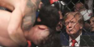 Donald Trump watches the flyweight bout between Alexandre Pantoja of Brazil and Brandon Royval of the USA.