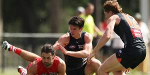 Brodie Grundy and Sam Taylor compete for the ball in a pre-season clash.