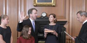 Chief Justice John Roberts,right,administers the Constitutional Oath to Judge Brett Kavanaugh in the Justices'Conference Room of the Supreme Court Building.