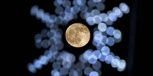 The rising moon,framed by Christmas lights in southern Missouri in the US on November 30.