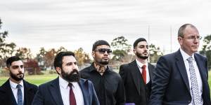 Taylan May (centre) walks into the board meeting with his army of lawyers on Tuesday