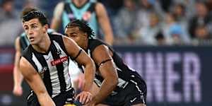 Nick Daicos gets away an early handball against Port Adelaide.