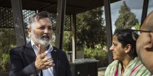 Melton Liberal candidate Graham Watt speaks to Thornhill Park residents Chander and Manisha Sharma.