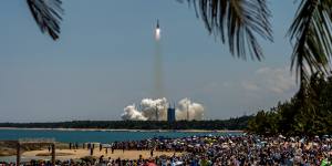 Tourists gather in Hainan to watch the Long March 5B rocket take off. 