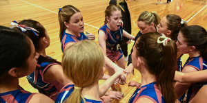 Westside Saints netballers in a huddle. Netball is Australia’s biggest participation sport for girls and women.