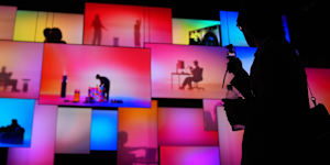 A person walks past screens at the LG Electronics booth during the CES tech show Tuesday,Jan. 6,2026,in Las Vegas. (AP Photo/Abbie Parr)