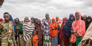 People displaced due to the drought stand around in a camp on the outskirts of Dollow,Jubaland,in Somalia hoping for aid and assistance.