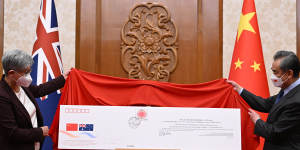 Penny Wong was presented with a giant commemorative envelope during a ceremony to mark the 50th anniversary of diplomatic relations between Australia and China. 