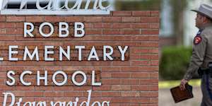 A state trooper walks into the Robb Elementary School in Uvalde,Texas,following a deadly shooting at the school.