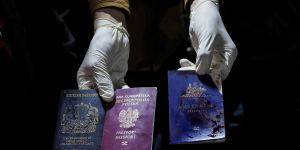 A man displays blood-stained British,Polish,and Australian passports