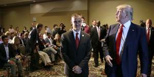 In this 2015 photo,Donald Trump walks with his then-campaign manager Corey Lewandowski after speaking at a news conference in Iowa.
