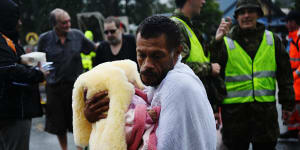 Noel Leon with his three-month-old baby rescued from the hotel he was staying in with his family.