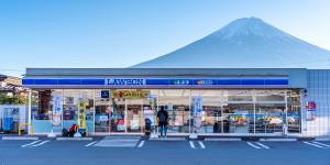 A Lawson convenience store with Mount Fuji in the background. 