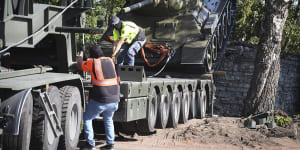 Workers removing a Soviet T-34 tank installed as a monument in Narva,Estonia,in August 2022.