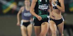 Jess Hull sprawled on the ground as Claudia Hollingsworth sprints to the line.