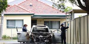 Police investigate a burnt-out car in Murdock Lane after two men were shot earlier on Osgood Street,Guildford.