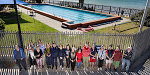 Opponents of the latest redevelopment plans for the Williamstown Swimming&Life Saving Club line the fence. 