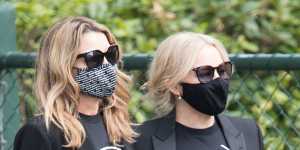 Sisters Kylie and Dannii Minogue at the funeral for Mushroom Group founder Michael Gudinski on Wednesday. 