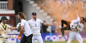 Ben Stokes of England and David Warner of Australia attempt to stop a “Just Stop Oil” protester.