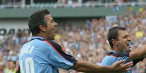 Steve Corica and Mark Rudan celebrate a goal together during their days as teammates at Sydney FC.