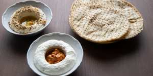 Almond taratour with dukkah (rear) and labne with muhammara,served with flatbreads.