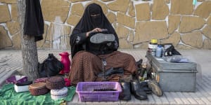 An Afghan woman cleans shoes in a street in Kabul,Afghanistan,last month. After the Taliban came to power in Afghanistan,women have been deprived of many of their basic rights.