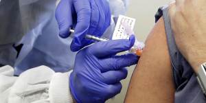 A patient receives receives a shot in clinical trial of Moderna's COVID-19 vaccine.