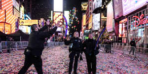 Members of the New York City Police Department (NYPD) celebrate New Year’s Eve in Times Square. Viewing areas that normally accommodate about 58,000 people were limited to about 15,000 to allow for social distancing.