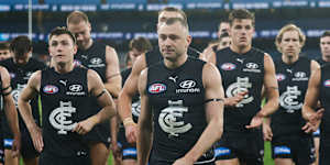 Will Hayward of the Blues leads the team off after his 200th game.