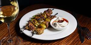 Char-grilled spiced chicken and green olive skewers.