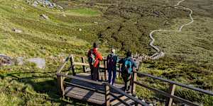 Hikers on Cuilcagh Boardwalk,in Ireland’s Hidden Heartlands,a destination for those who prefer unhurried journeys.