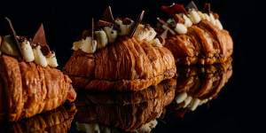 The croissant is topped with mascarpone chantilly cream,tempered chocolate shards,salted cookie crumb and Belgian truffles.