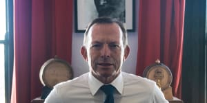 Former PM,Tony Abbott in front of a portrait of Hemingway,Author of Old Man and the Sea