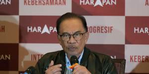 Opposition leader Anwar Ibrahim fronts a news conference early on Sunday.