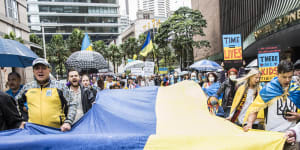 The Ukrainian flag is carried along Elizabeth Street in Sydney during a Stop War in Ukraine rally on Saturday.